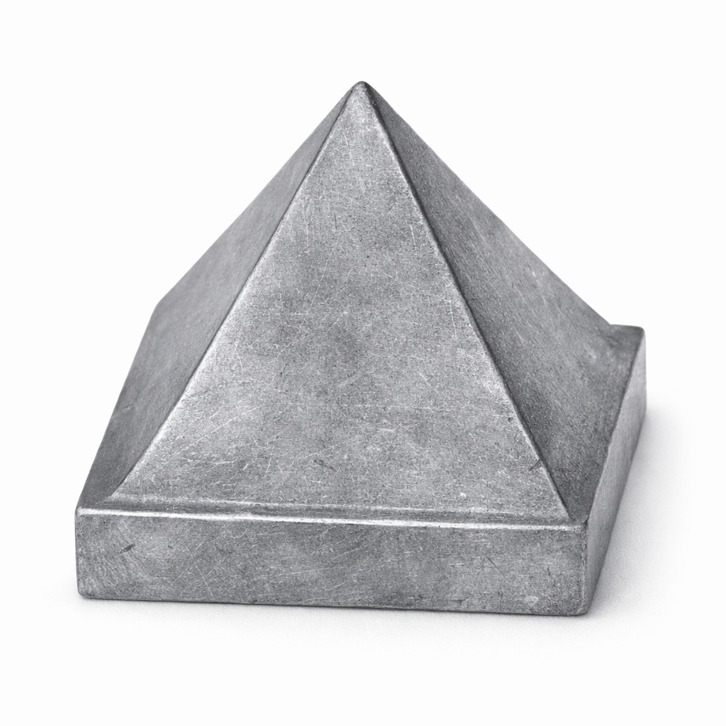 Solid lead metal Vastu pyramid isolated in angled view on white background