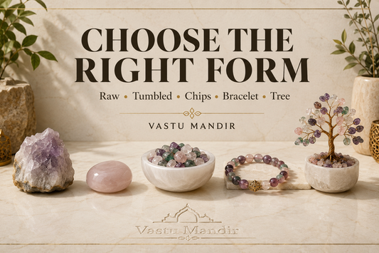 Raw crystal, tumbled stone, crystal chips, bracelet, and crystal tree displayed on a luxury stone surface to explain different crystal forms.