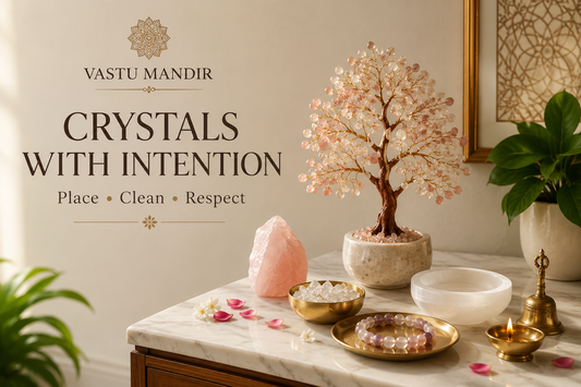 Crystal tree, raw stone, crystal chips bowl, selenite plate, bracelet, brass diya, and plant placed as Vastu home décor in a modern Indian home.