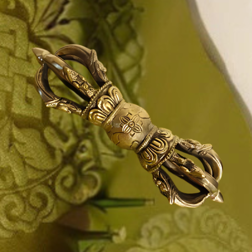 Large pure brass Vajra Dorje displayed on an embossed green textile