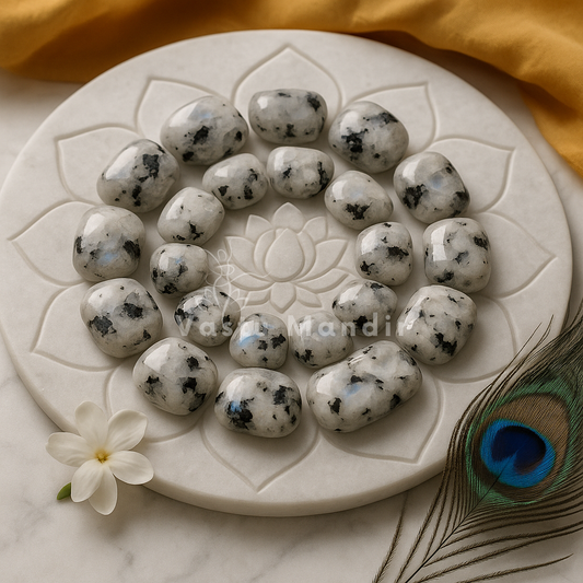 Rainbow moonstone pieces arranged in a circular pattern on a clear decorative plate