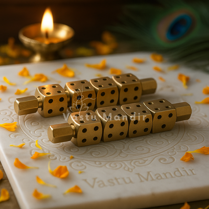 Brass Ramal Pass dice pair in a sacred setting with marigold petals