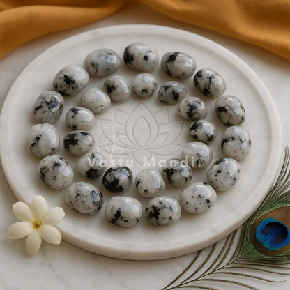 Closer view of rainbow moonstone pieces arranged around the centre of a glass plate