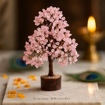 Rose quartz crystal tree displayed in a dark, softly lit spiritual setting