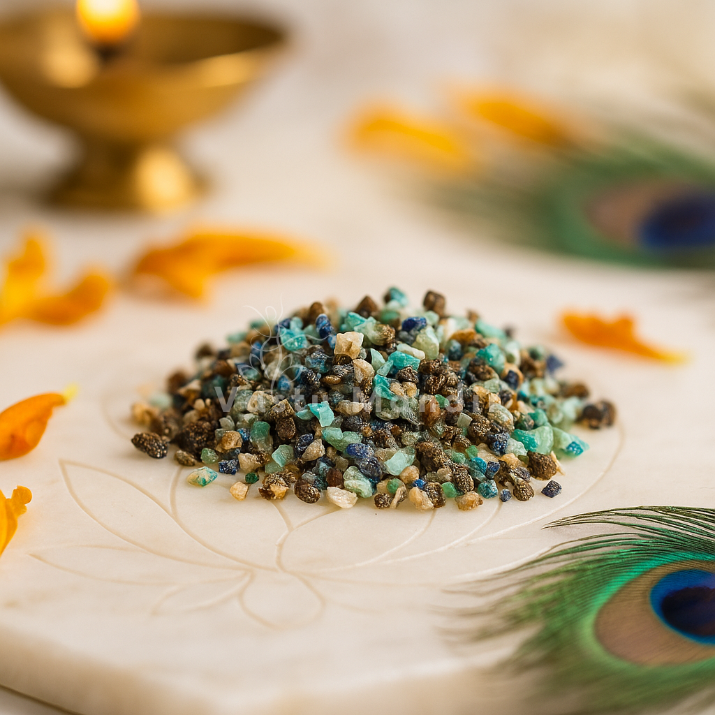 Azurite crystal chips arranged on a carved white plate with marigold petals and a softly lit diya