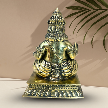 Brass Lord Dhan Kuber Ji idol rear view showing the decorated throne and base