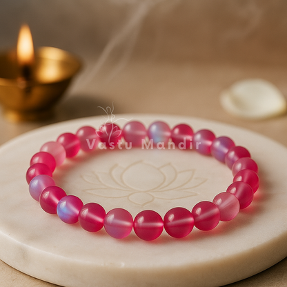 Natural light pink aura quartz crystal bracelet shown in a second hand-held product view