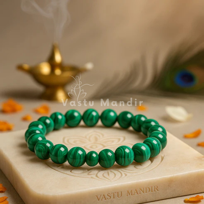 Natural malachite crystal bracelet shown in a second hand-held product view