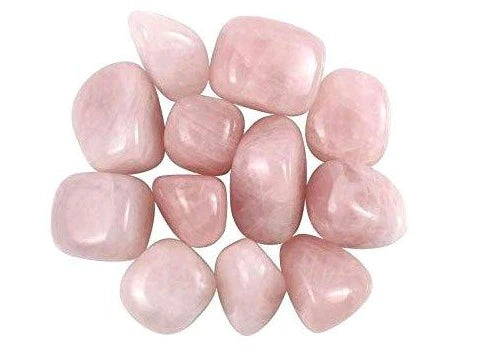 Group of rose quartz tumbled stones isolated on a clean white background