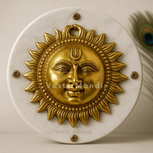 15 cm brass sun face wall hanging mounted on a white marble disc with peacock feather accents