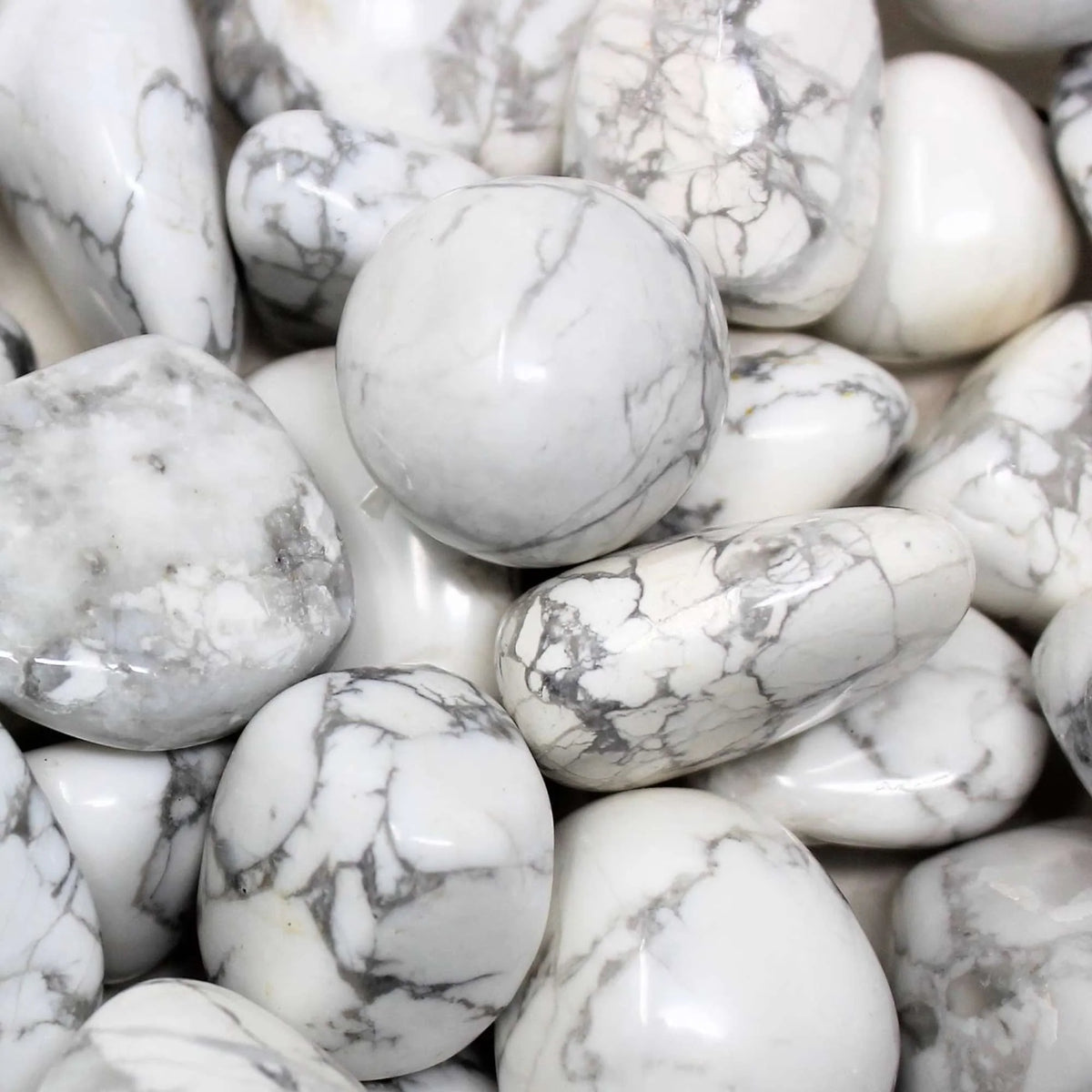 Natural howlite tumbled stones arranged in a styled spiritual setting