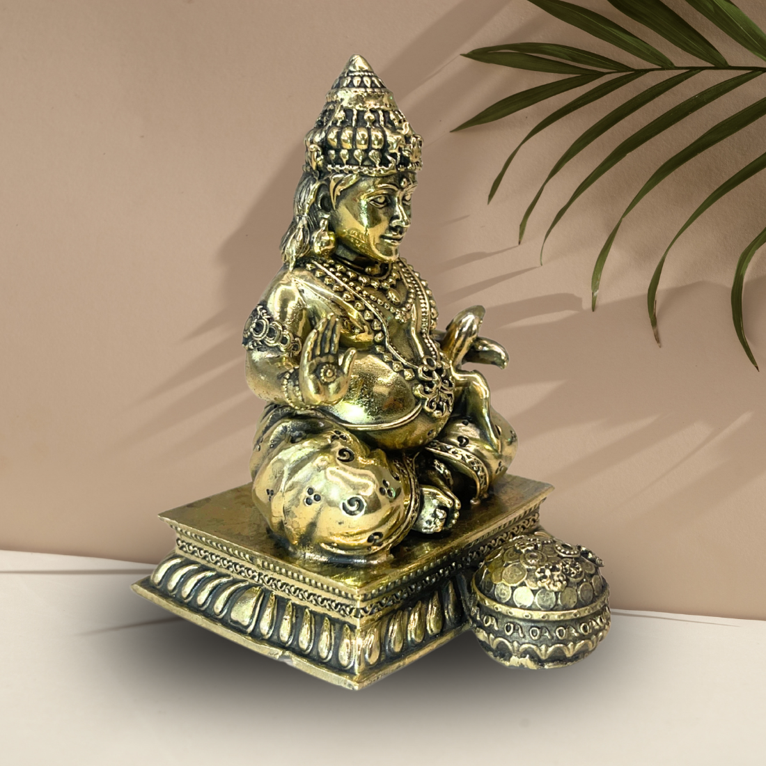 Brass Lord Dhan Kuber Ji idol alternate side angle with the money pot beside the idol