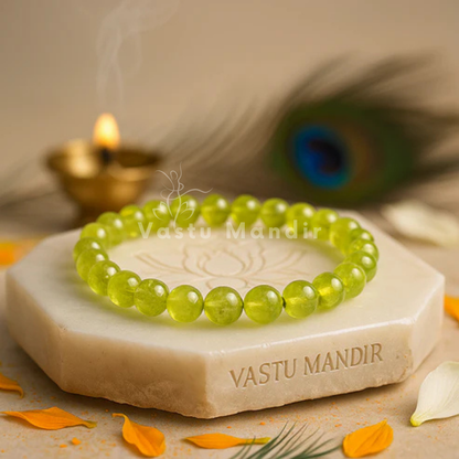 Natural peridot crystal bracelet shown with a hand in a lifestyle photograph
