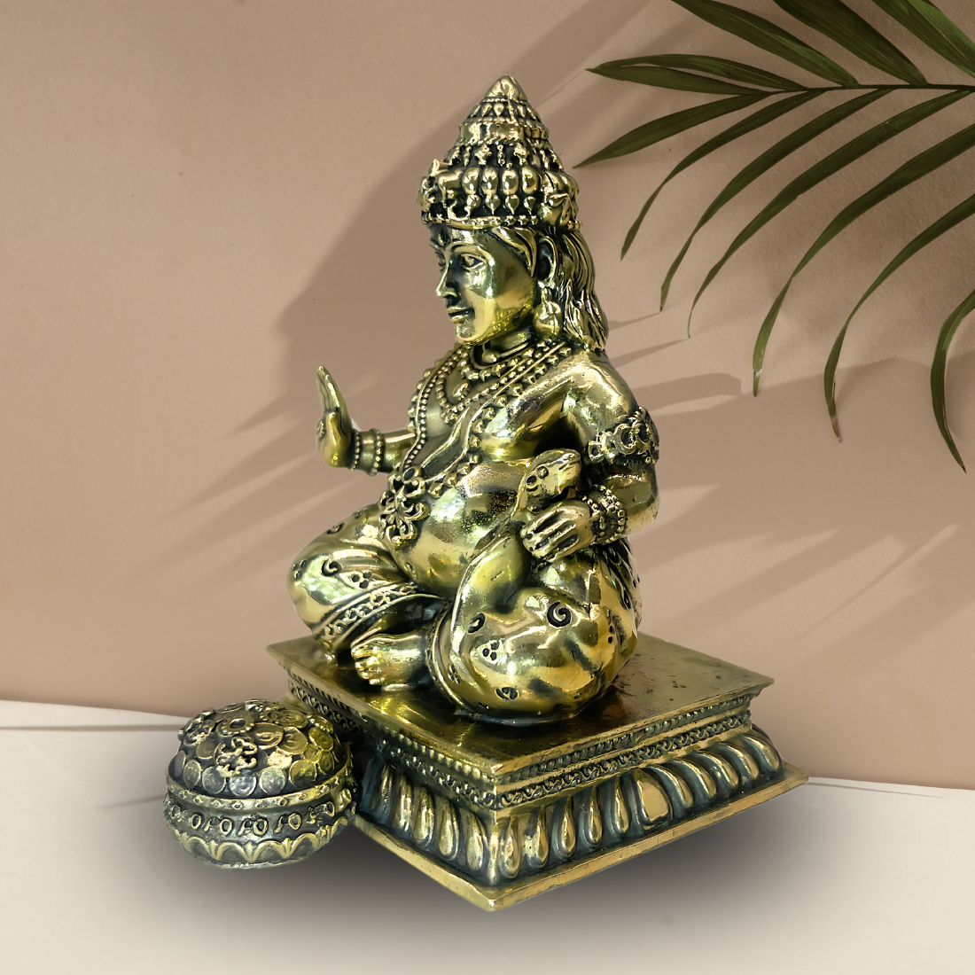 Brass Lord Dhan Kuber Ji idol right-side view showing the pot and square base