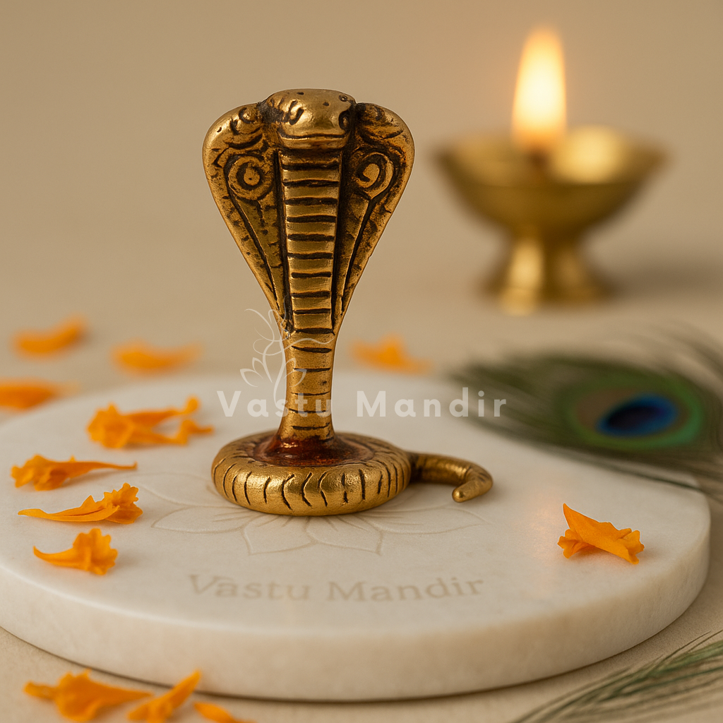 Three-headed brass snake idol alternate front view on a marble plate