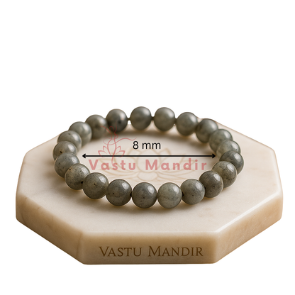 Natural labradorite crystal bracelet presented with a hand for visual scale