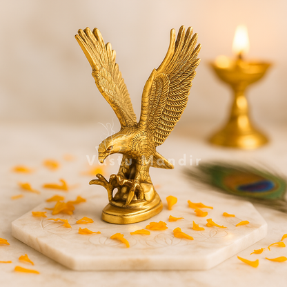 Brass eagle idol Vastu remedy arranged in a styled spiritual setting