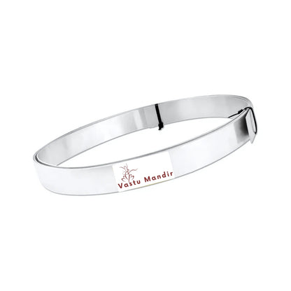 Aluminium Vastu strip formed into a shallow oval coil on a white background