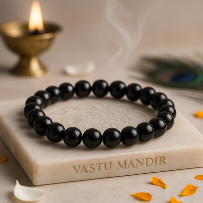 Natural black obsidian crystal bracelet shown in a second hand-held product view