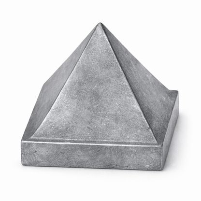 Solid lead metal Vastu pyramid isolated in angled view on white background