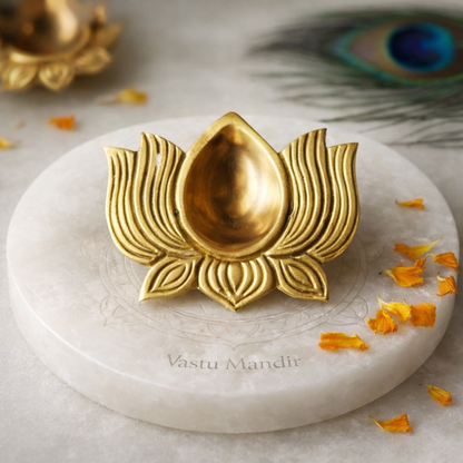 Brass lotus diya arranged in a styled spiritual setting