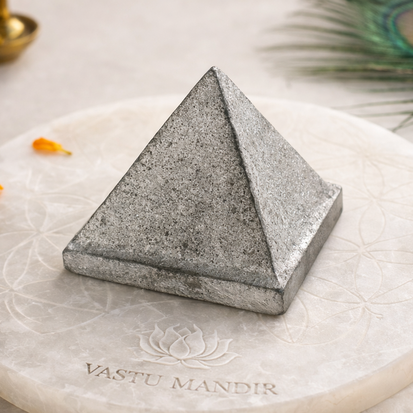 Solid Iron Metal Pyramid – front-left angled view showing two pyramid faces