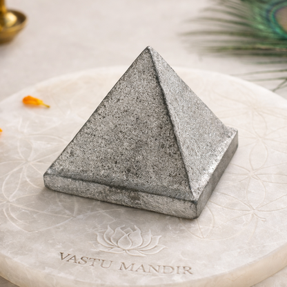 Solid Iron Metal Pyramid – front-left angled view showing two pyramid faces