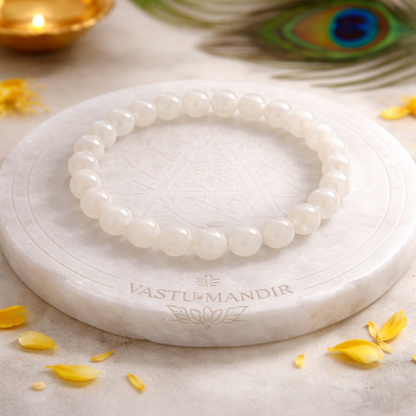 Natural white moonstone crystal bracelet shown in a separate hand-held product photograph