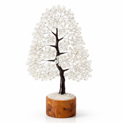 Decorative tree with white beads on a wooden base against a white background
