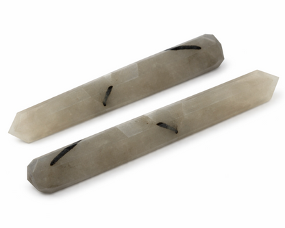 Black rutile crystal pencil on a clean white background