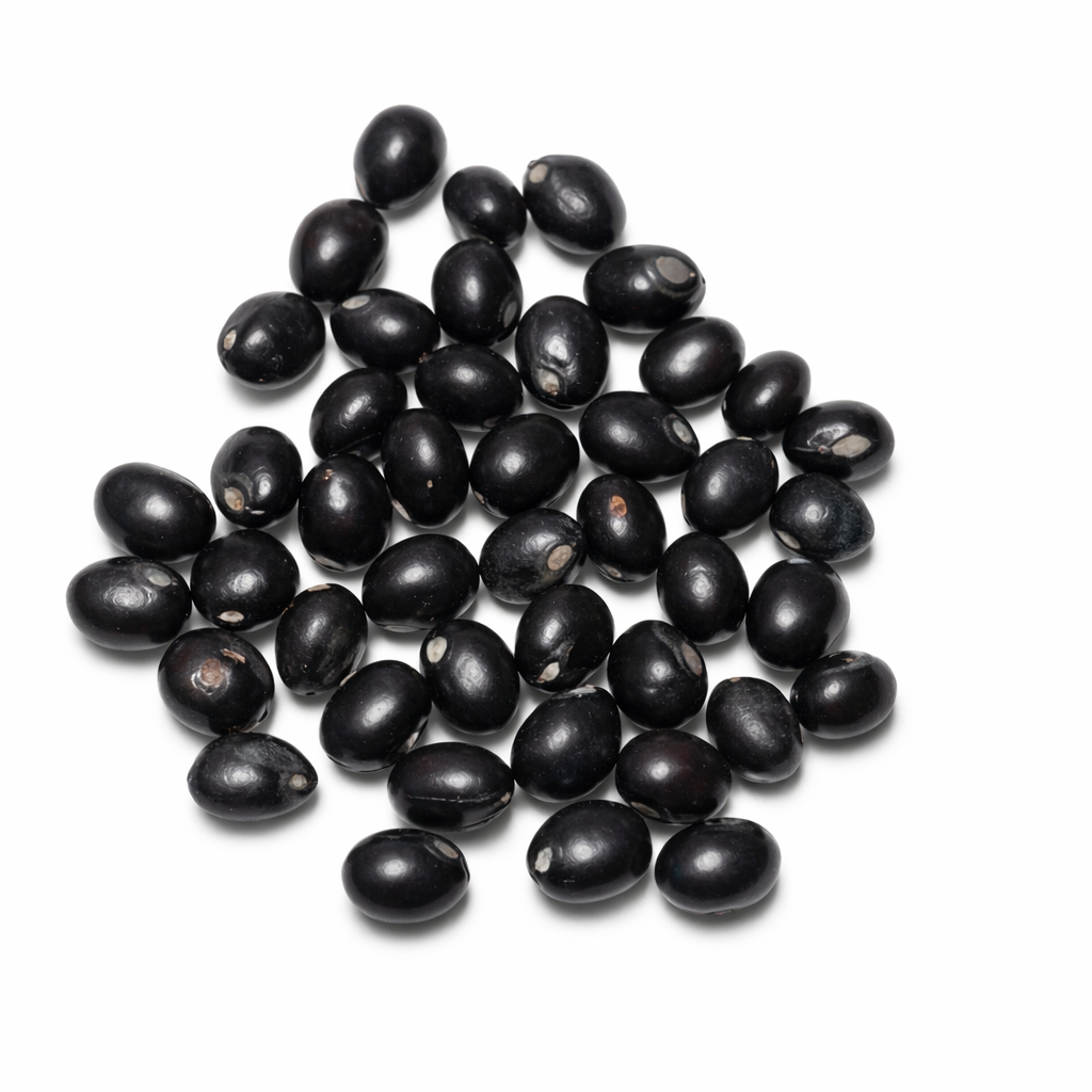 Pile of glossy black gumchi seeds isolated on a clean white background