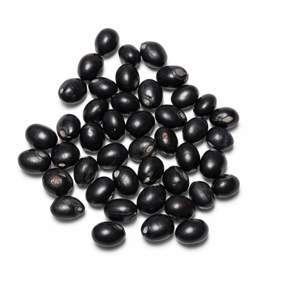 Pile of glossy black gumchi seeds isolated on a clean white background