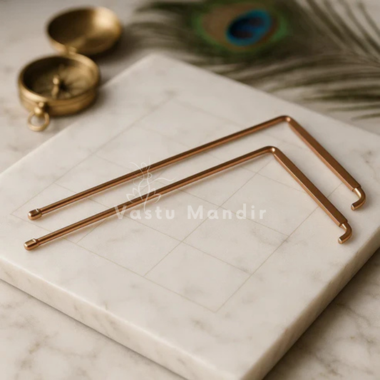 Copper L-shaped dowsing rod pair displayed on a marble board with sacred accents