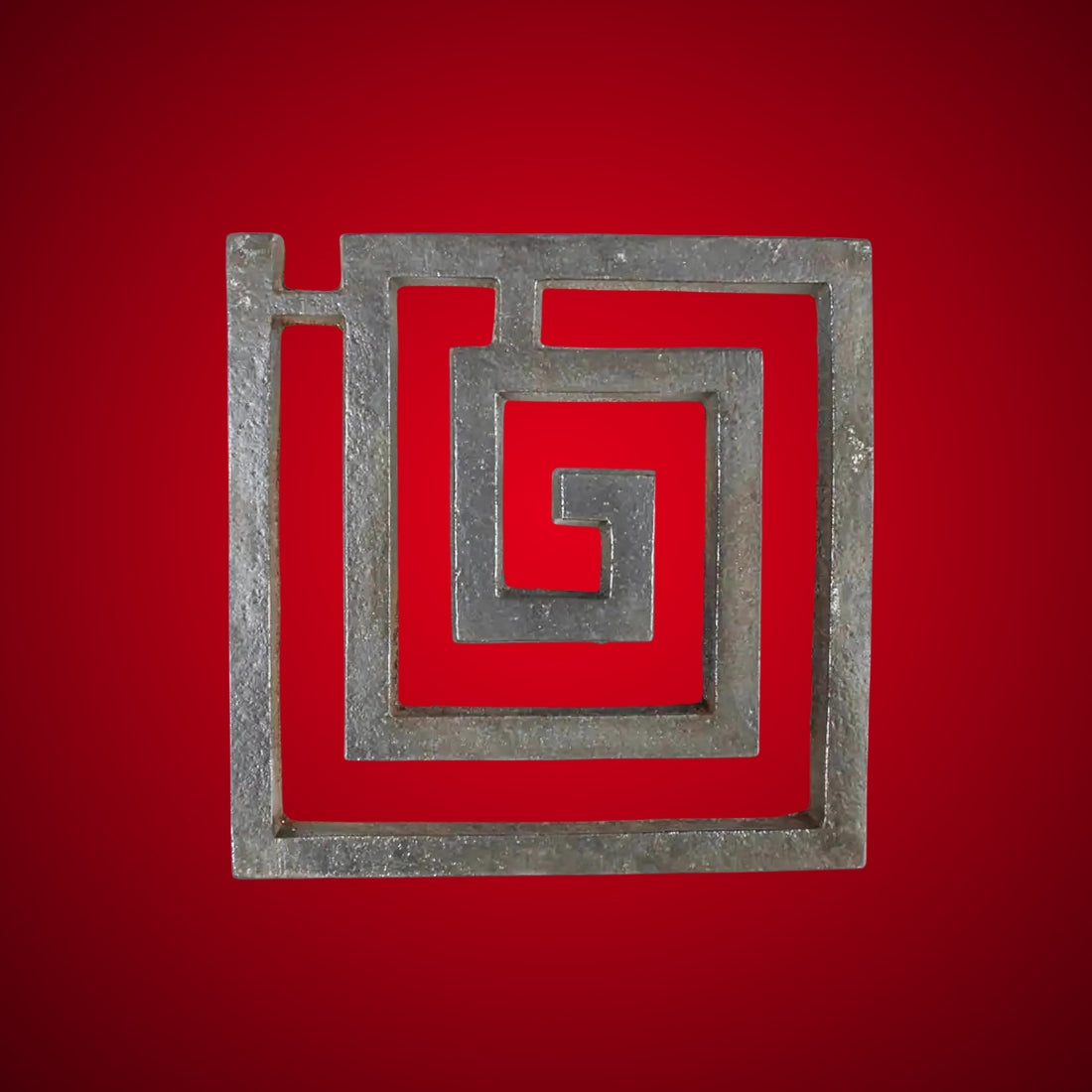 Iron square spiral helix centred on a deep red background