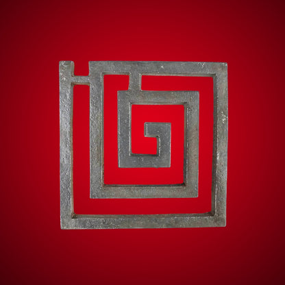 Iron square spiral helix centred on a deep red background