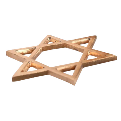 Angled view of the copper star helix lying on a white background