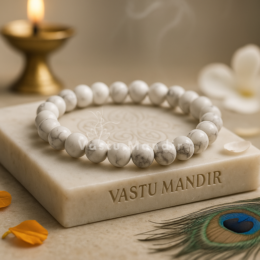 White Howlite - beaded bracelet on a 'Vastu Mandir' block with a candle and peacock feather in the background