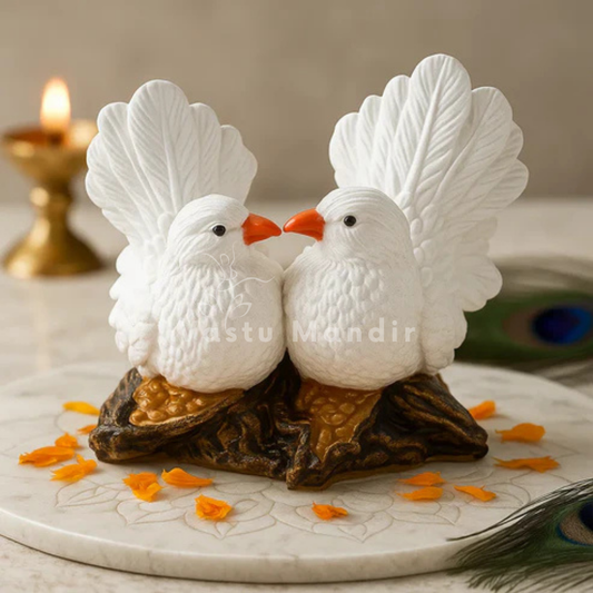 White love birds resin sculpture displayed on a marble pedestal with sacred accents