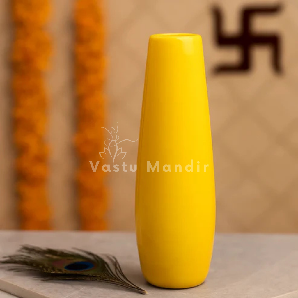 Large yellow decorative resin vase shown in an elegant home interior setting