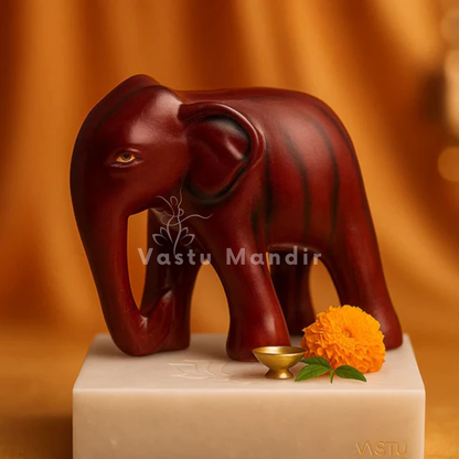 Royal red elephant resin sculpture Vastu remedy arranged in a warm low-light product setting