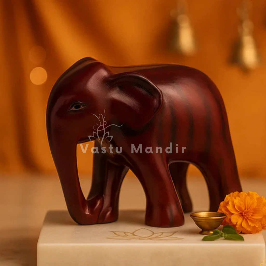 Royal red elephant resin sculpture Vastu remedy displayed in a dark, softly lit spiritual setting