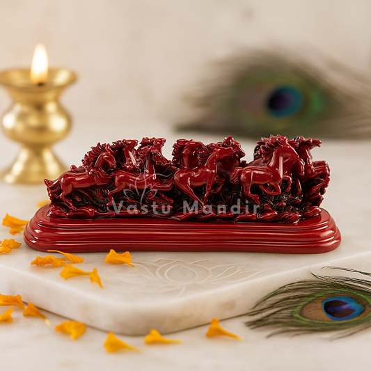Twelve red running horses resin sculpture displayed with a peacock feather and brass diya
