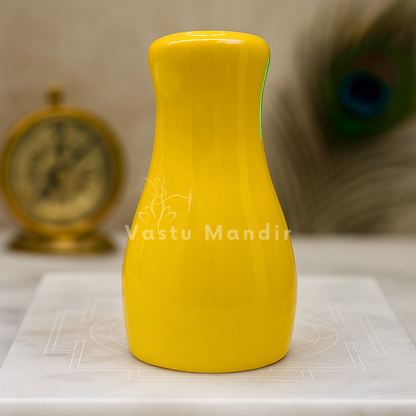 Small yellow decorative resin vase styled in a premium home interior
