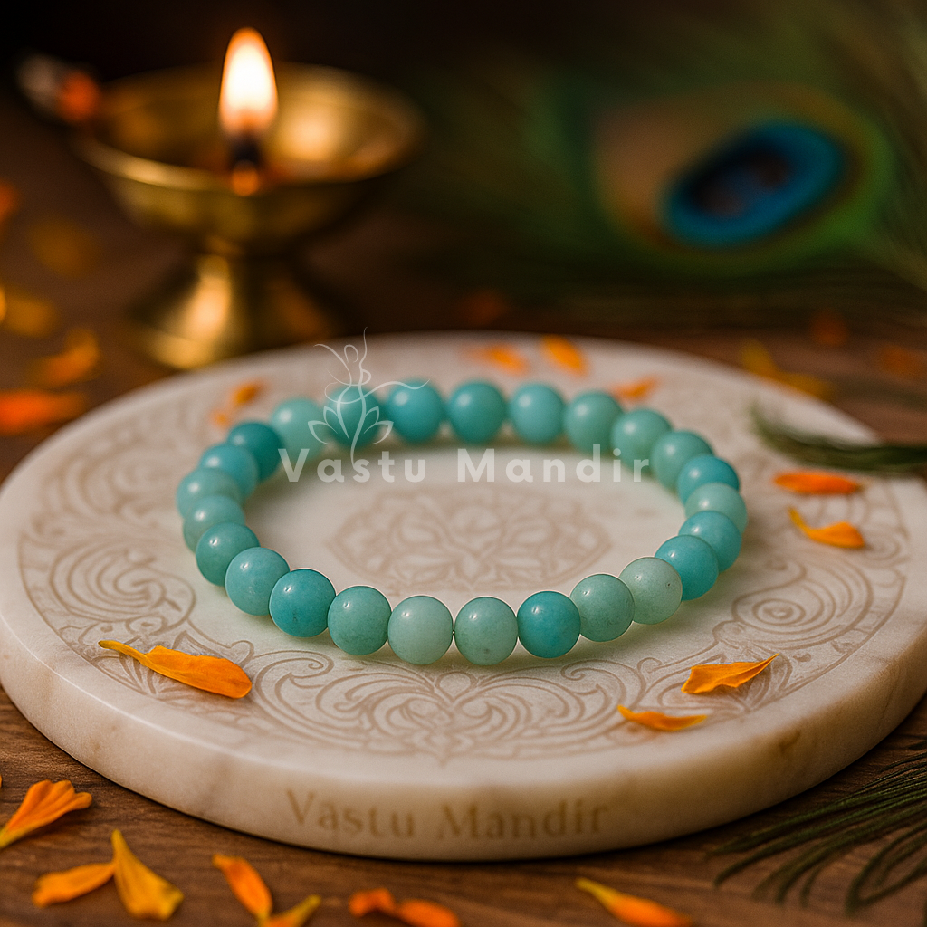 Vastu Amazonite Bracelet 8mm Beads – on a decorative plate with 'Vastu Mandir' branding, surrounded by orange flowers and a lit candle.