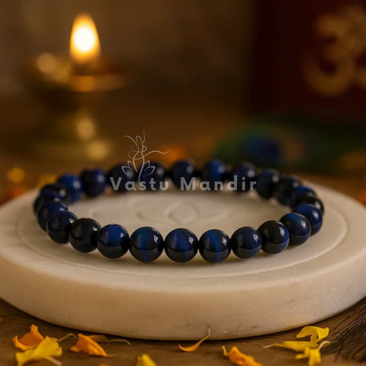 Natural blue tiger eye crystal bracelet shown with a hand in a lifestyle photograph