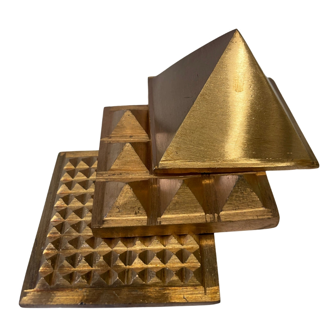 Three-layer brass pyramid shown from above in a stepped arrangement on a white background