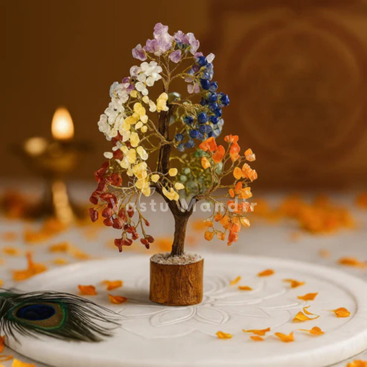 7 chakra crystal tree displayed in a dark, softly lit spiritual setting