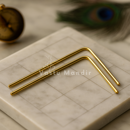 Brass L-shaped dowsing rods displayed in a sacred marble setting
