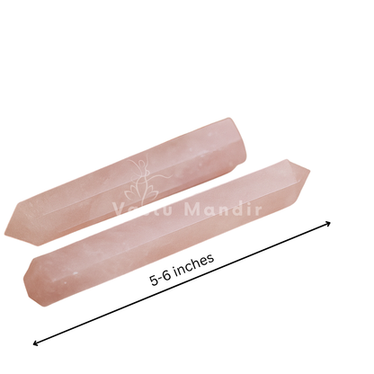 Rose quartz crystal pencil presented with clear space on a white background
