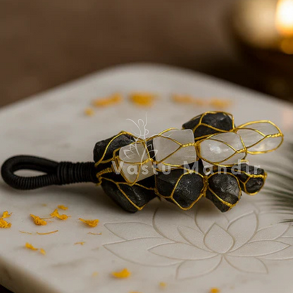 Black tourmaline & selenite dual crystal chunk displayed in a dark, softly lit spiritual setting